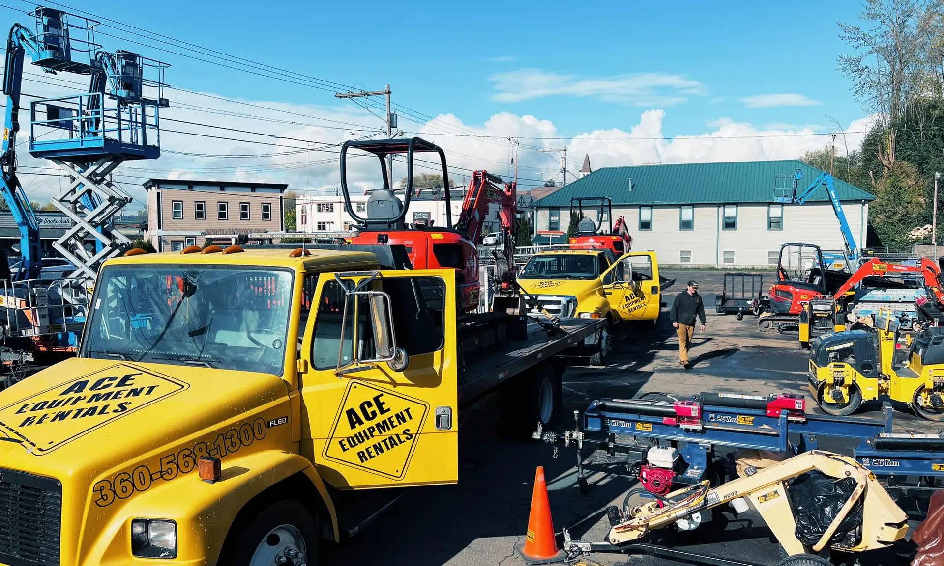 ace equipment compact excavator on trailer in rental equipment yard